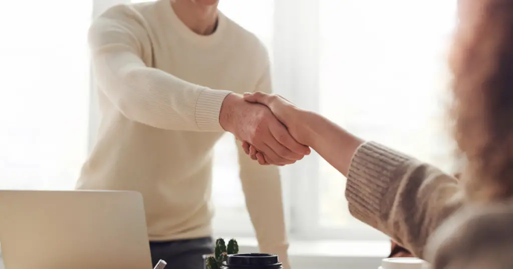 Two people shaking hands in an office