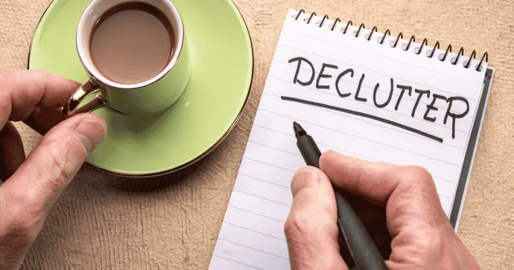 Drinking coffee and writing "declutter" in a notepad