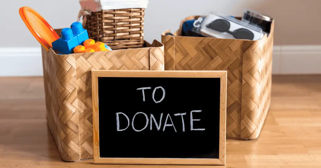 Baskets of items with a chalkboard in front that says "to donate"