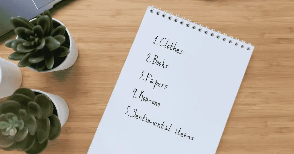 List of KonMari method steps in a notebook
