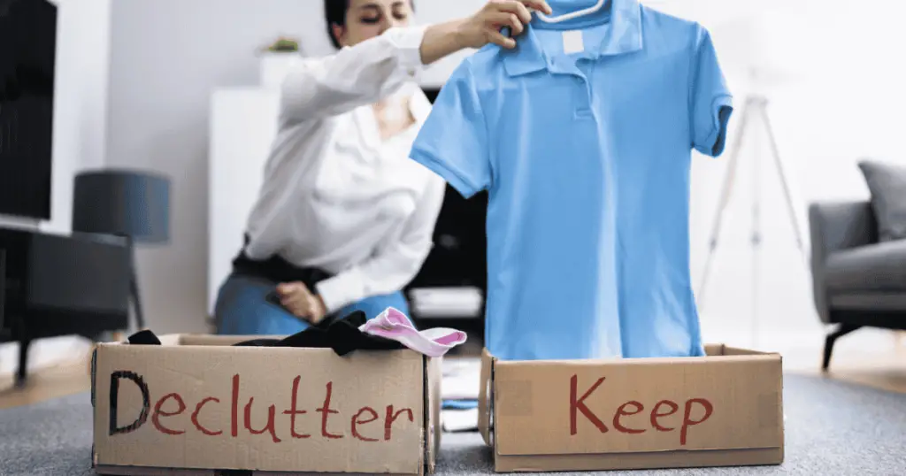 Sorting clothes into declutter and keep boxes