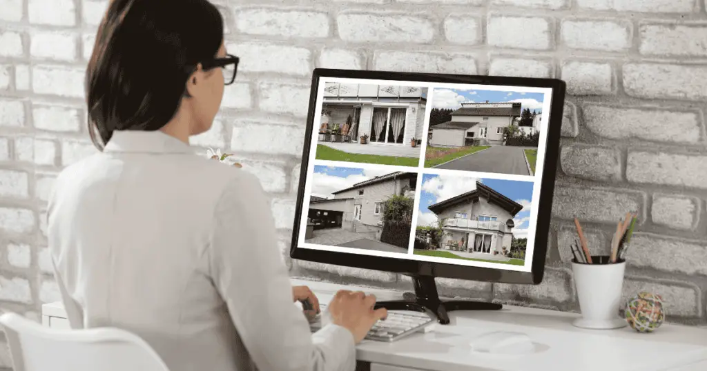 Lady looking at homes on a desktop computer