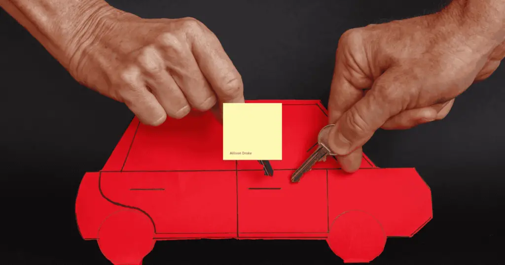 Cutout of a red car with a sticky note on it