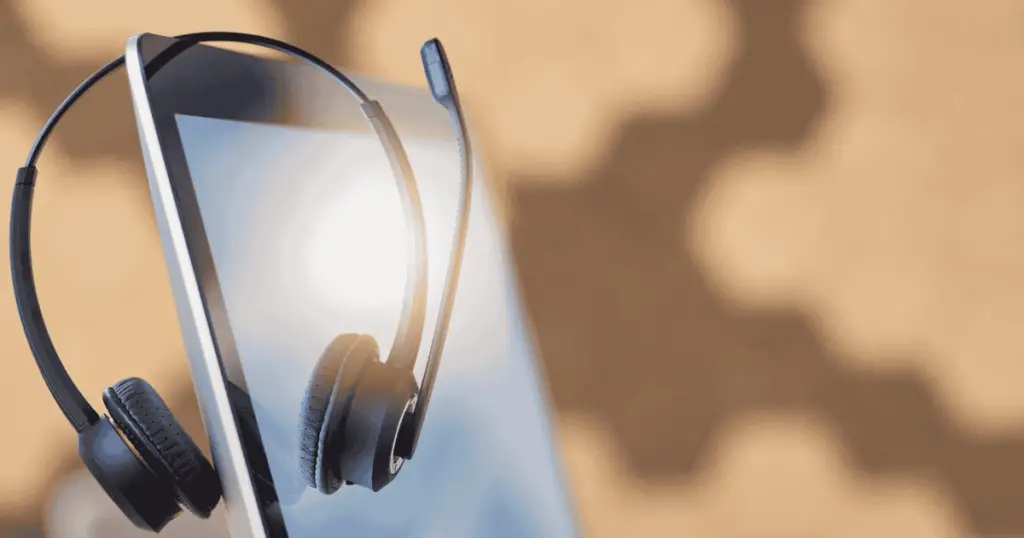 Microphone headset resting on a laptop monitor