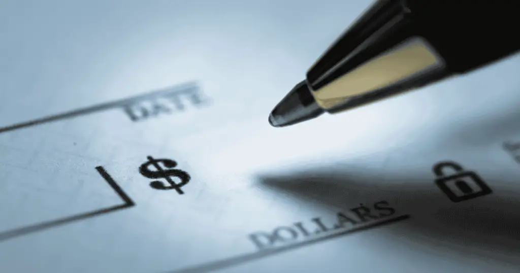 Filling out a check with a pen