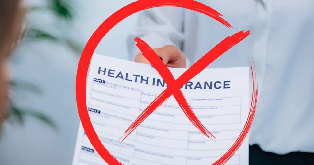 Person holding a health insurance form with a circled X over it